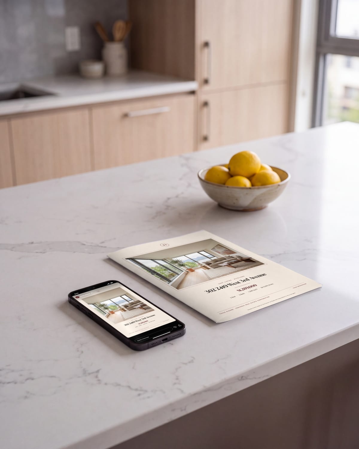 A sample agent's folded listing brochure and a phone showing her Just Listed post on a kitchen island